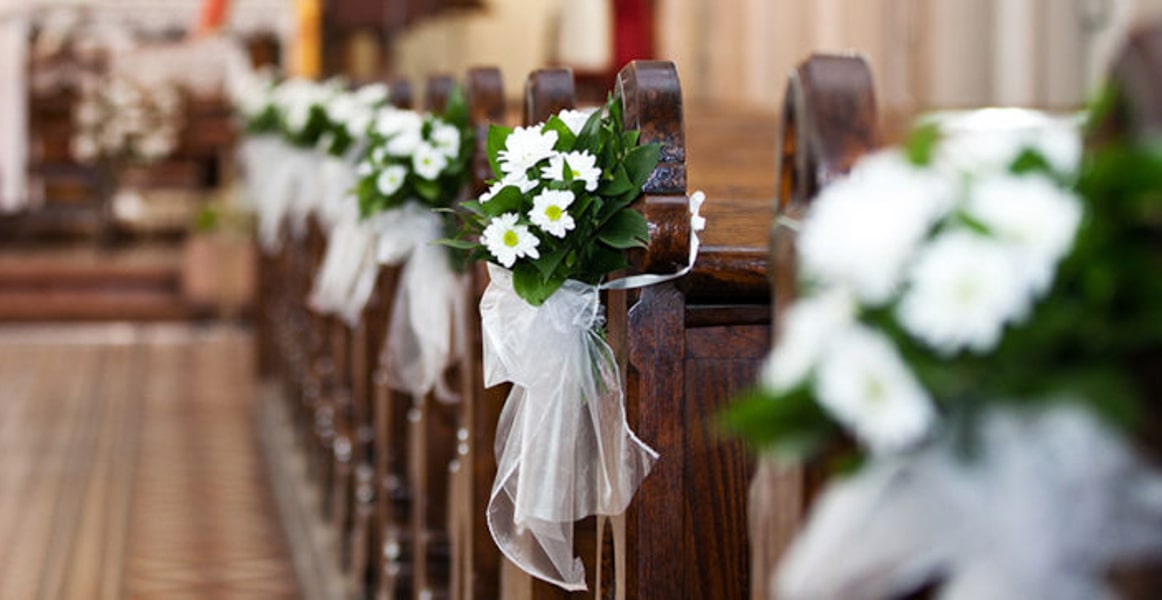 Church pews decorated with flowers