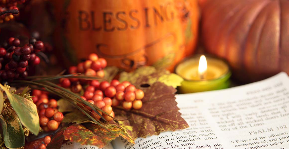 scripture book surrounded by fall foliage