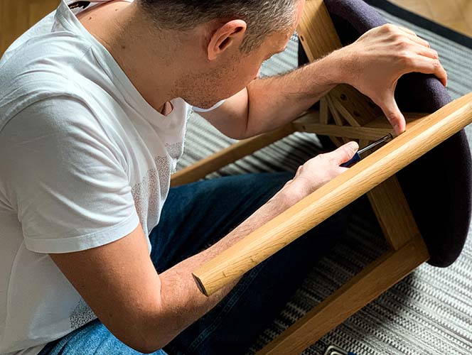 A man tightening a chair frame