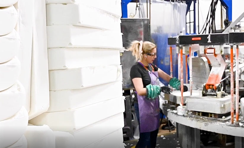 Manufacturing employee attending to the foam station