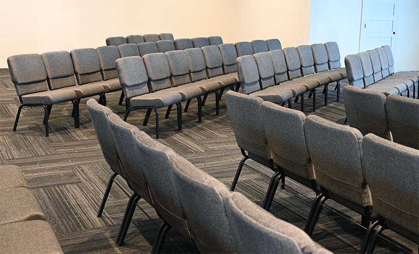 diagonal rows of gray church chairs