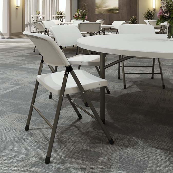 Folding chairs and tables arranged in a worship space