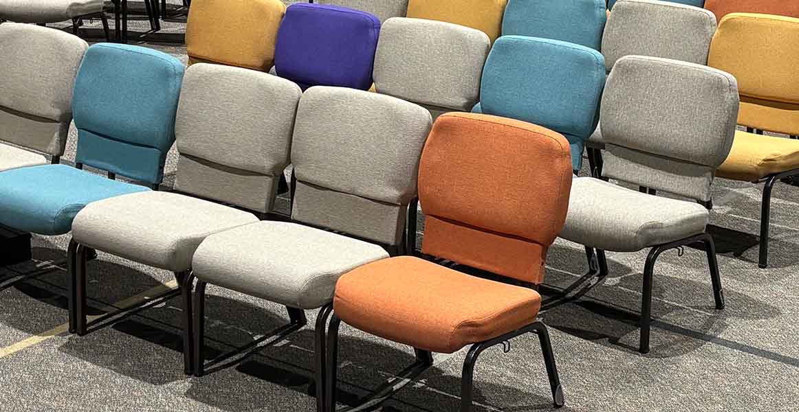 Des rangées de chaises colorées et bien rangées à l'église Bethany Wesleyan