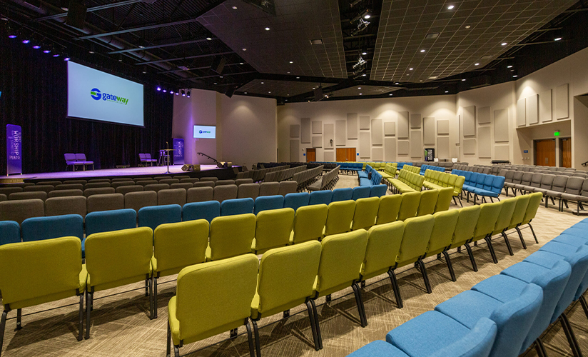 Vibrant and neat rows of chairs face a neat worship stage setting.