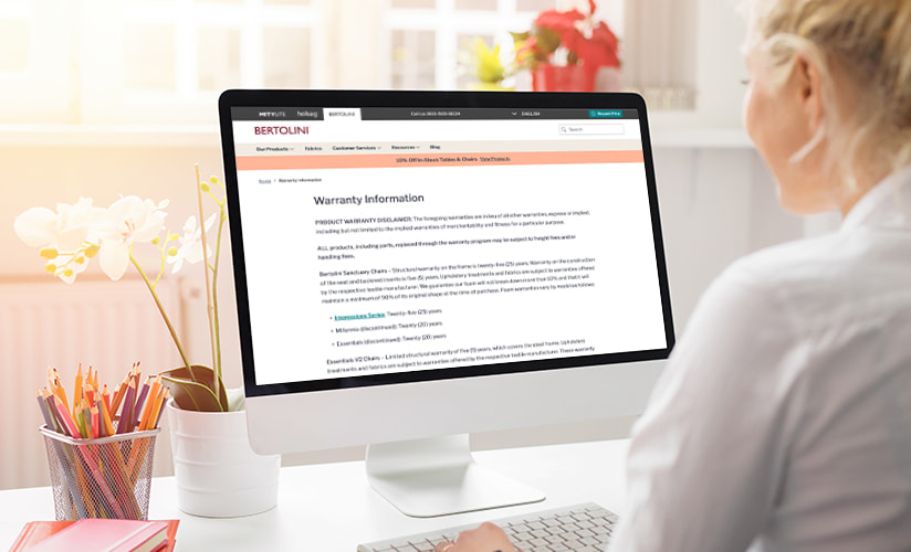 Woman on a desktop computer reviewing Warranty details