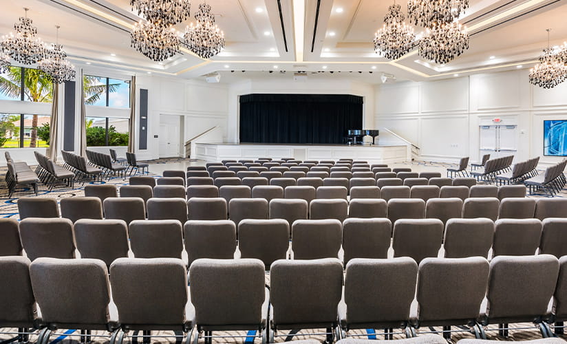 Image of an open, well-lit worship hall with a dozen rows of worship chairs