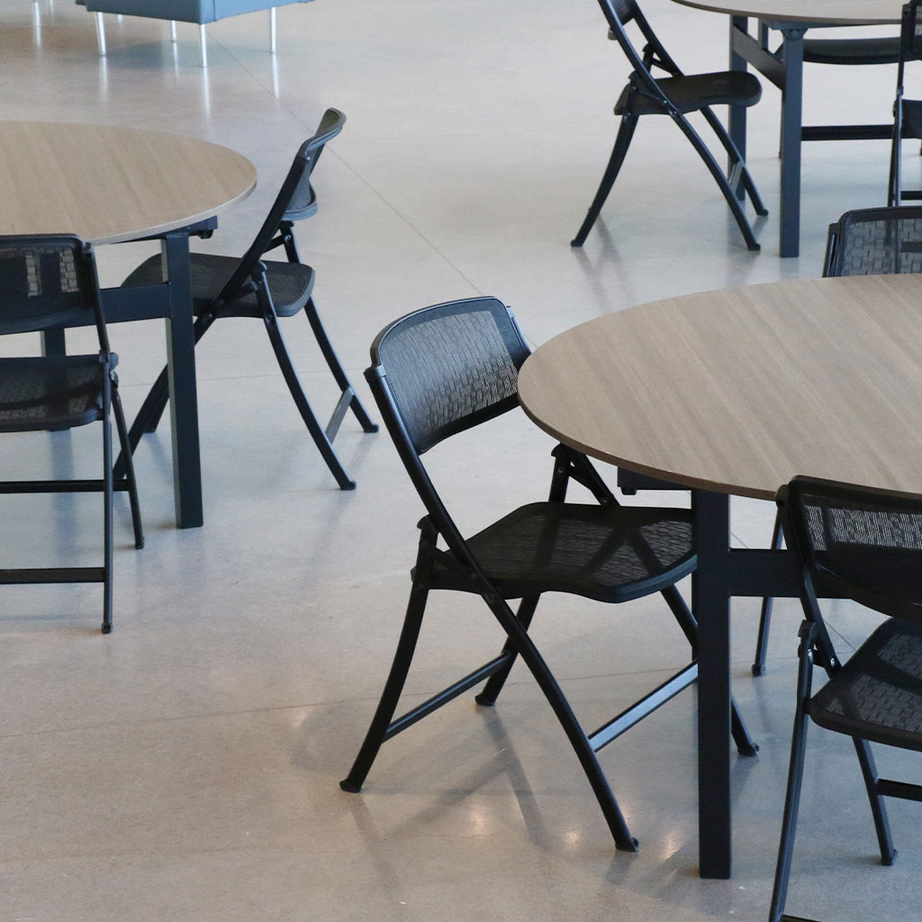 MeshOne chairs arranged around tables in a social lobby setting